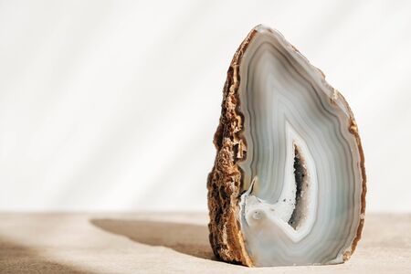 A polished agate mineral on a wooden table. Copy, empty space for text.の写真素材