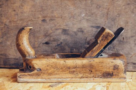 Old construction tools on a wooden workbench flat lay background with copy space. Old woodworking hand toolの写真素材