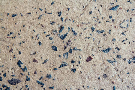 Structure of concrete surface with admixtures of stones as background image. Rough building material of gray colorの写真素材