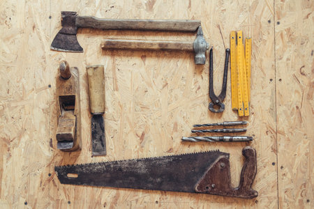 Old construction tools on a wooden workbench flat lay background. Carpenter table. Woodworkの写真素材