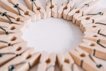 Group of wooden clothespins arranged in a circle isolated on white background. Copy spaceの写真素材