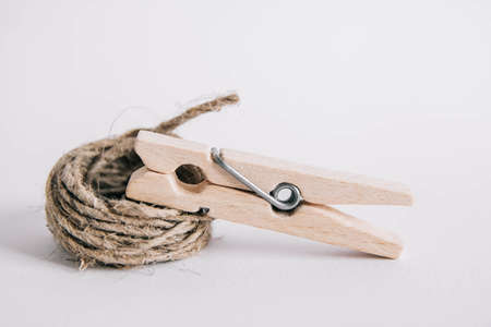 Wooden clothespin with rope on white background. Place for your textの写真素材