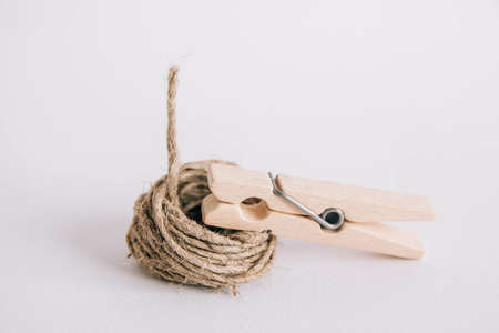 Wooden clothespin with rope on white background. Place for your textの写真素材