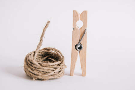 Wooden clothespin with rope on white background. Place for your textの写真素材