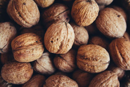 Walnuts on the table close-up. Background with walnutsの写真素材