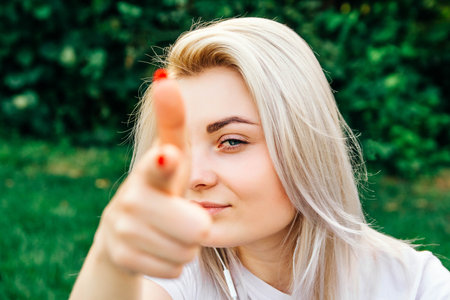 Portrait of beautiful blonde girl smiling, making shot of fingers in camera with happy face. Creativity and photography conceptの写真素材
