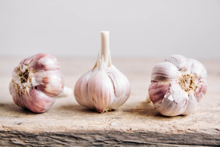 Garlic in a wicker basket on a wooden table background. Copy, empty space for text.の写真素材