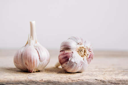 Garlic in a wicker basket on a wooden table background. Copy, empty space for text.の写真素材