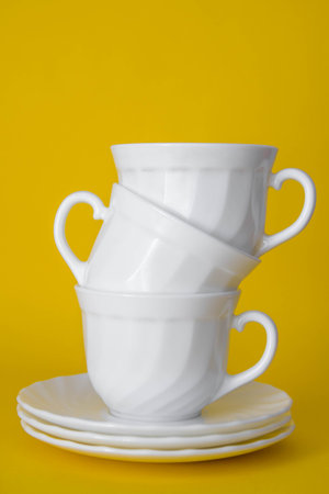 Plastic bottle and sponges for washing dishes on a white table. Cleaning equipment. Space for text.