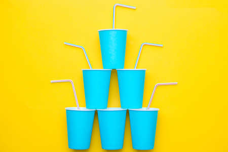 White plastic spoon on blue and yellow background. Top view. Copy, empty space for text.の写真素材