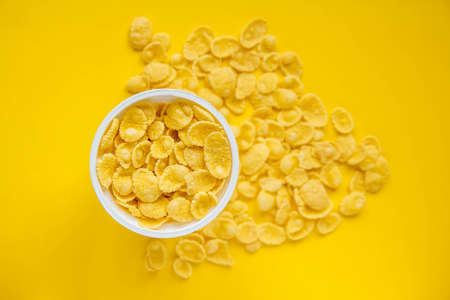White plastic spoon on blue and yellow background. Top view. Copy, empty space for text.の写真素材