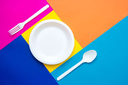 Pyramid of blue paper disposable cups on yellow background. Set for party. Copy, empty space for text.の写真素材