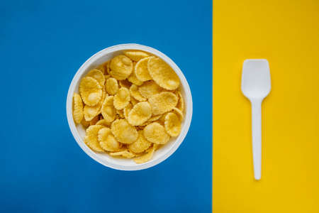 Pyramid of blue paper disposable cups on yellow background. Set for party. Copy, empty space for text.の写真素材