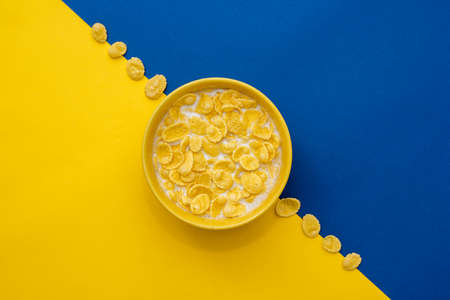 Pyramid of blue paper disposable cups on yellow background. Set for party. Copy, empty space for text.の写真素材