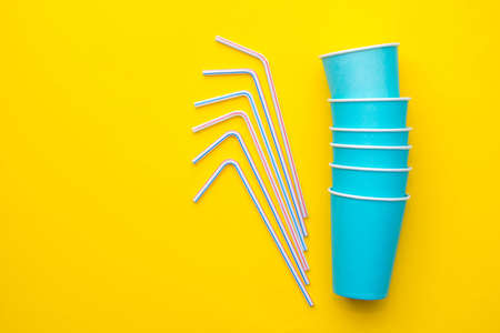 Yellow rubber glove for cleaning hang on blue background. Top view. Minimalist Style. Copy, empty space for text.の写真素材