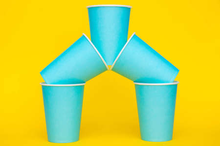 Yellow rubber glove for cleaning hang on blue background. Top view. Minimalist Style. Copy, empty space for text.の写真素材