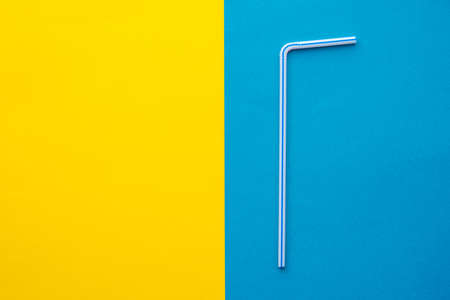 Plastic white spoon and fork on yellow background. Cooking utensil. Cutlery sign. Top view. Minimalist Style. Copy, empty space for text.の写真素材