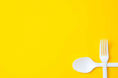 Pattern from blue paper disposable cups on yellow background. Set for party. Top view. Minimalist Style. Copy, empty space for text.の写真素材