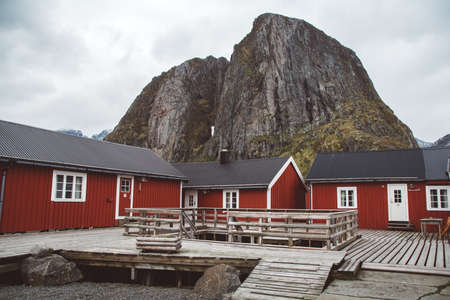 Norway rorbu houses and mountains rocks over fjord landscape scandinavian travel view Lofoten islands.のeditorial素材
