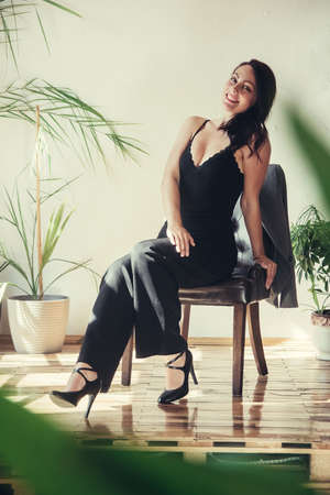 Beautiful girl model dressed in black clothes in Loft style interior.の写真素材