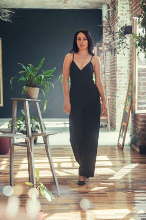 Beautiful girl model dressed in black clothes in Loft style interior.の写真素材