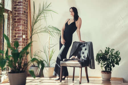 Beautiful girl model dressed in black clothes in Loft style interior.の写真素材