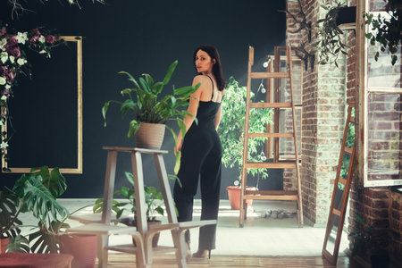 Beautiful girl model dressed in black clothes in Loft style interior.の写真素材