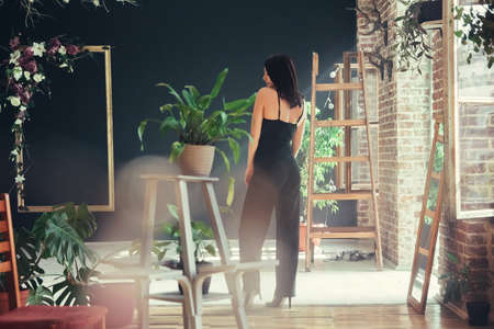 Beautiful girl model dressed in black clothes in Loft style interior.の写真素材