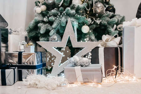 Christmas background with illuminated fir tree and presents under a beautiful christmas tree.の写真素材
