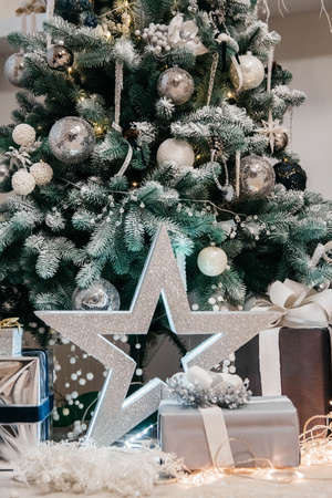 Christmas background with illuminated fir tree and presents under a beautiful christmas tree.の写真素材