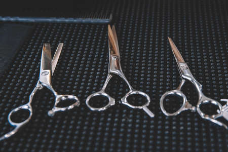 Stylish professional barber scissors. Haircut accessories. Hairdresser salon concept, hairdressing tool set.の写真素材