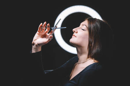 Beautiful woman hairdresser with scissors in hand. Barbershop advertising concept. Place for text or advertising.の写真素材