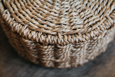Element of a round wicker basket on a wooden background. Pattern of round texture. Top view. Copy, empty space for textの写真素材