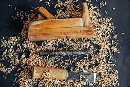 Wood shavings on black background. Background of fresh wood shavings. Copy, empty space for text.の写真素材