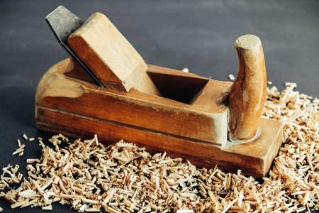 Wood shavings on black background. Background of fresh wood shavings. Copy, empty space for text.の写真素材