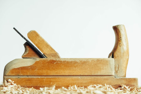 Wood drill bit with wooden shavings on black background. Copy, empty space for text.