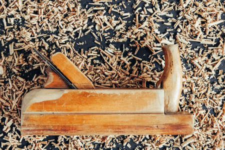 Wood drill bit with wooden shavings on black background. Copy, empty space for text.の写真素材