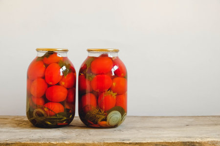 Glass transparent bottle on wooden table on white wall background. Copy, empty space for text.