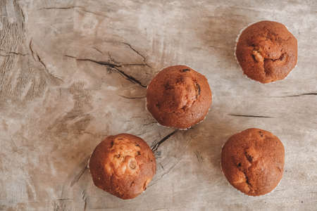 Chocolate cupcakes with candle on wooden table. Copy, empty space for text.の写真素材