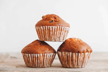 Chocolate cupcakes with candle on wooden table. Copy, empty space for text.の写真素材