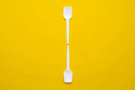 Bar of chocolate in silver foil on yellow background. Top view. Copy, empty space for text.の写真素材