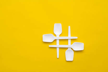Bar of chocolate in silver foil on yellow background. Top view. Copy, empty space for text.の写真素材