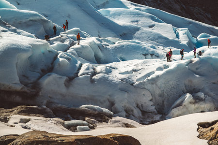 Private group of hiker walking on glacier. Glacier group of people hiking mountains.