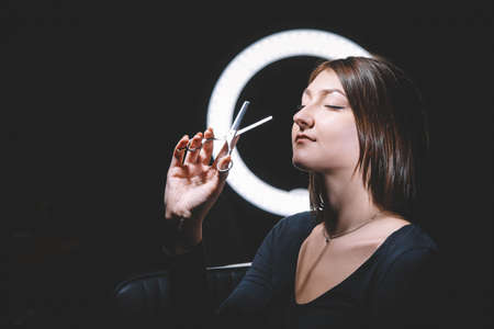 Beautiful woman hairdresser with scissors in hand. Barbershop advertising concept. Place for text or advertising.の写真素材