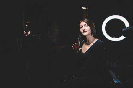 Beautiful woman hairdresser with scissors in hand. Barbershop advertising concept. Place for text or advertising.の写真素材