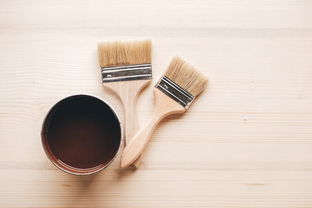 Paint brushes with a wooden handle and natural bristles on a wooden background. Repair concept. Copy, empty space for text.の写真素材