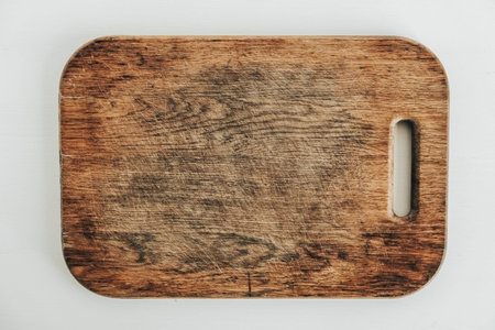 Old wooden cutting board on a white background. Top view. Copy, empty space for text.