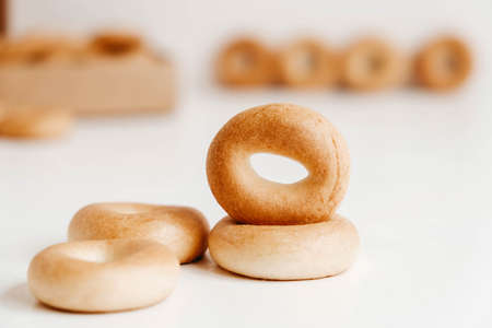 Drying or mini round bagels on a white wooden background. Copy, empty space for text.の写真素材