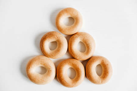 Drying or mini round bagels on a white wooden background. Copy, empty space for text.の写真素材