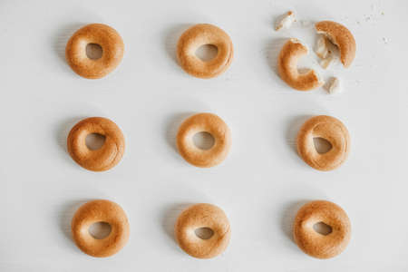 Drying or mini round bagels on a white wooden background. Top view. Copy, empty space for text.の写真素材